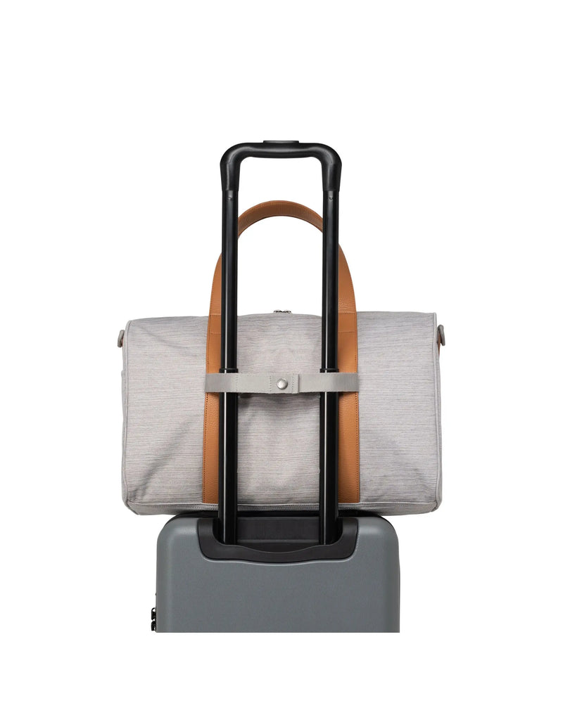 Light heather grey carry on size duffle bag.